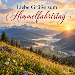 Blick über ein nebliges Bergtal bei Sonnenaufgang mit Blumenwiese im Vordergrund und dem Gruß "Liebe Grüße zum Himmelfahrtstag".