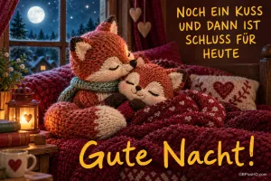 Zwei gestrickte Füchse kuscheln unter einer Decke: "NOCH EIN KUSS UND DANN IST SCHLUSS FÜR HEUTE Gute Nacht!".