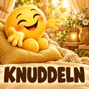 Fröhlicher gelber Smiley mit ausgebreiteten Armen sitzt auf einem gemütlichen Strickkissen bei Kerzenlicht, umgeben von kleinen Herzen und Blumen, darunter das Wort KNUDDELN
