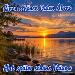 Sonnenuntergang am See mit Bergen, Schilf und Steg; die Grüße lauten "Einen schönen guten Abend" und "Hab später schöne Träume".
