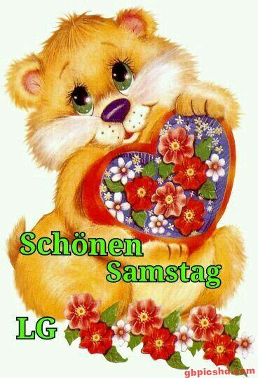 Niedlicher Teddybär mit Blumenherz wünscht einen schönen Samstag.