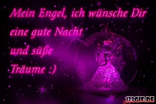 Leuchtend pinkfarbener Engel in einer Kugel mit gut Nacht Wunsch in pinker Schrift bei Nacht.