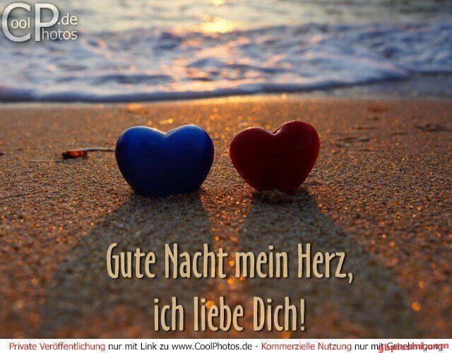 Zwei Herzsteine am Strand bei Sonnenuntergang mit Gute-Nacht-Gruß.