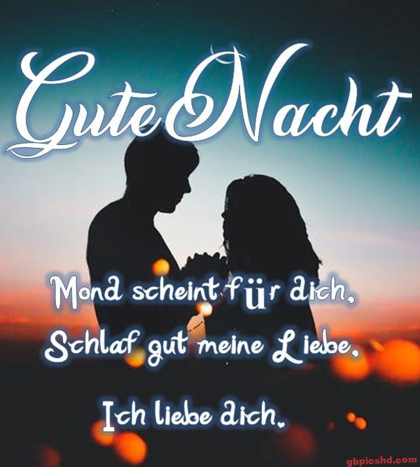 Romantische Silhouetten eines Paars bei Sonnenuntergang mit Gute Nacht Gruß auf Deutsch.